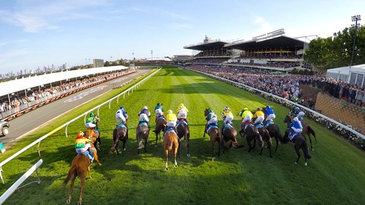 Horses racing at Moonee Valley during Cox Plate Day, capturing the prestige and excitement